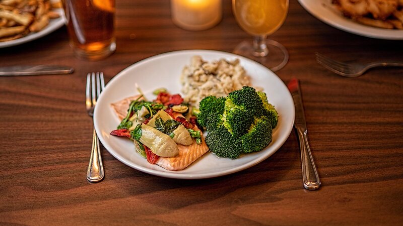 Pan seared salmon entree with side of broccoli and rice