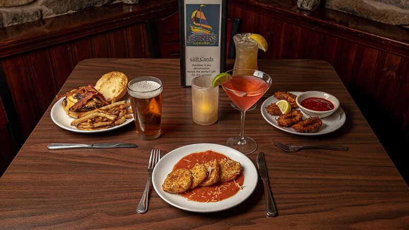 Mutiple appetizers and drinks with focus on fried mozzarella appetizer